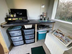 a small kitchen with a counter with drawers at Coutts Glamping in Wadebridge