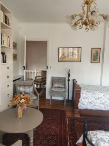a living room with a bed and a table at La Romantique in Paris