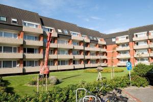a large apartment building with bikes parked in front of it at Holiday Residenz Holiday Residenz B40 in Borkum