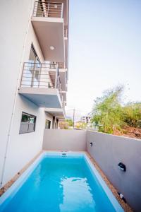 a swimming pool in the backyard of a house at L'Etoile in Flic-en-Flac