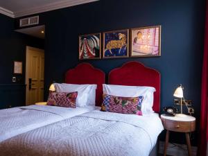 a bedroom with a large bed with a red headboard at Spread Eagle in London