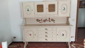 a white dresser with flowers on it at DA VALDES in Segusino
