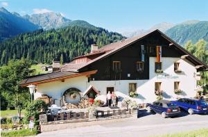 a group of people standing in front of a building at Gasthof Luggau in Maria Luggau