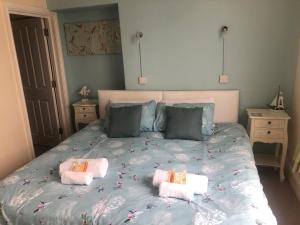 a bedroom with a bed with towels on it at Wayfarer Inn in Instow