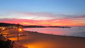 a view of a beach at night with a sunset at Hotel Egitarso Sul Mare in San Vito lo Capo