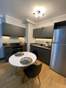 a kitchen with a white table and a refrigerator at Central Modern Apartment by Siena Suites in Istanbul