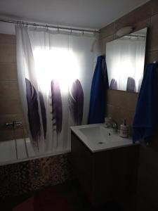 a bathroom with a sink and a shower curtain at Mainalo View House in Vytina
