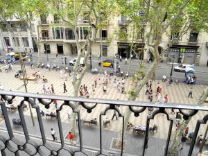 a group of people walking around a busy city street at Hotel Lloret Ramblas in Barcelona