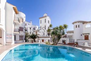 a large swimming pool in front of a building at Sitges Blue - completamente reformado en 2025 in Sitges