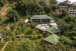 an aerial view of a resort with a swimming pool at Tabulia Tree in Manuel Antonio