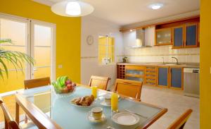a kitchen with a table with a bowl of fruit on it at DUPLEX EN EL CENTRO DE GALDAR in Gáldar