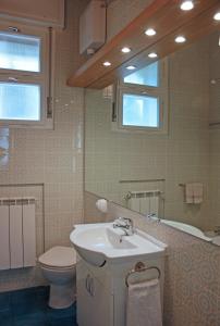 a bathroom with a sink and a toilet at Edera Residence in Trieste