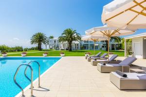 a swimming pool with lounge chairs and umbrellas at Casa Scordilli in Chania Town