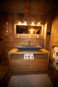 a bathroom with a sink in a wooden room at La Maison Du Seigneur in La Salle