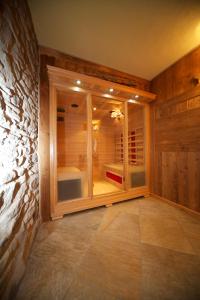 a room with a large window in a stone wall at La Maison Du Seigneur in La Salle