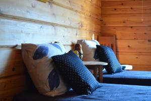 a room with blue and white pillows on a bed at Villa Sea Golf Rönnäs in Loviisa