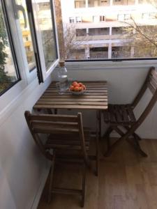 a table with a bowl of fruit and a window at Charming Suite Private Wc & Balcony in Lisbon