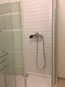 a shower with a glass door in a bathroom at Charming Suite Private Wc & Balcony in Lisbon