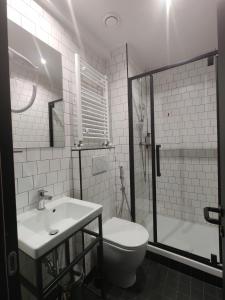a bathroom with a toilet and a sink and a shower at YellowSquare Milan in Milan