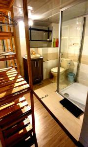 a bathroom with a glass shower and a toilet at Aparta estudio Xenia in Bogotá