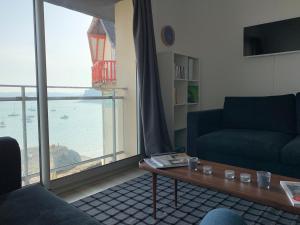 a living room with a view of the ocean at Appartement Design VIII - Port Rosmeur - Sublime vue Mer in Douarnenez