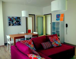 a living room with a red couch and a table at Casa Julia in Cividale del Friuli
