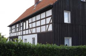 a black and white building with windows at Harzhaus in Wienrode