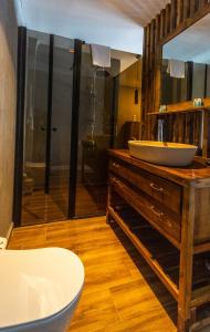 a bathroom with a sink on a wooden dresser at Sifne Thermal Otel in Çeşme