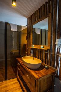 a bathroom with a large bowl sink on a wooden dresser at Sifne Thermal Otel in Cesme