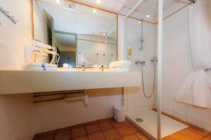 a bathroom with a sink, toilet and shower at Club Vacances Bleues Domaine de Château Laval in Gréoux-les-Bains
