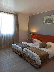 Postel nebo postele na pokoji v ubytování Hotel Restaurant Miramar L'orchidée