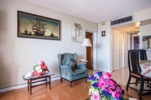 a living room with chairs and a painting on the wall at Sky Club @ Montego Bay Club Resort in Montego Bay