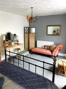 a living room with a bed and a couch at Inalong - Quirky property with sea views above an Ale House in The Mumbles