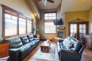 a living room with leather couches and a fireplace at Buffalo Lodge Townhomes 1293 in Silverthorne