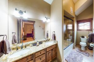 a bathroom with two sinks and a shower and a toilet at Buffalo Lodge Townhomes 1293 in Silverthorne +59 photos