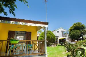 a house with a porch and a yard at VILLA SIRIZ "Ti Siriz" in Fouché