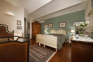 a bedroom with a bed and a table with flowers on it at Agriturismo Il Gioco Dell'Oca in Barolo