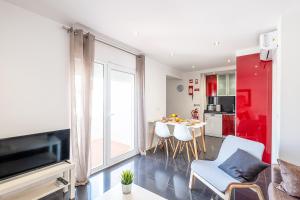 a kitchen and living room with a table and chairs at Atlantic Breeze Apartments in Albufeira
