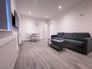 a living room with a couch and a table at Ilford Luxury Apartments in Ilford