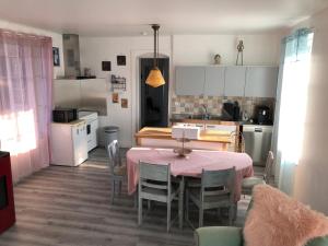 a kitchen with a table and chairs in a room at Appartement in Chateau Saint Claude an der Saone in Mantoche