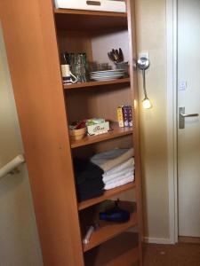 a closet with a shelf with towels on it at Texelzon in Den Hoorn