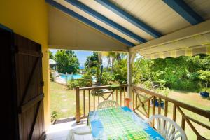 a porch with a table and chairs on a balcony at VILLA SIRIZ "Ti Siriz" in Fouché