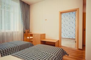 a hotel room with two beds and a window at Hotel Paluba in Samara