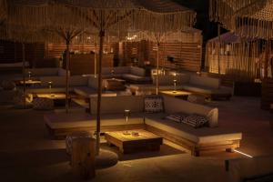 a living room with couches and tables with candles at Maya Beach Resort in Massa Lubrense