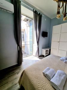 a bedroom with a bed and a window with a balcony at DUOMO 152 NAPOLI in Naples