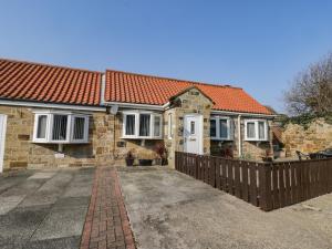 a brick house with an orange roof at The Stables in Redcar