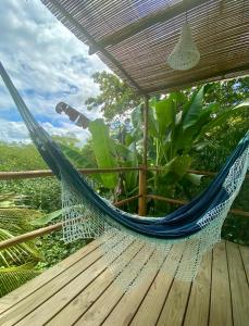 a hammock on a deck with a view at Beco do Pescador in Caraíva