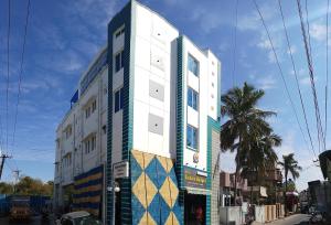 a building with a mosaic facade on a street at Saibala Budget Airport Hotel in Chennai