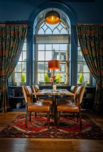 een eetkamer met een tafel en stoelen en een raam bij Black Bull in Lauder