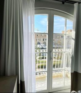 an open window with a view of a balcony at Dock 1 Boutique Hotel in Cospicua